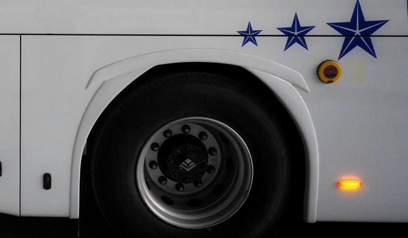 Bus wheel arch with alloy wheel and an Attention Power Switch service label